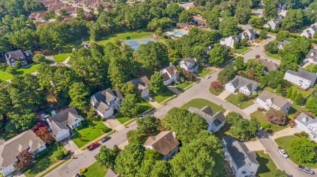 a view of a house with a yard and wooden fence