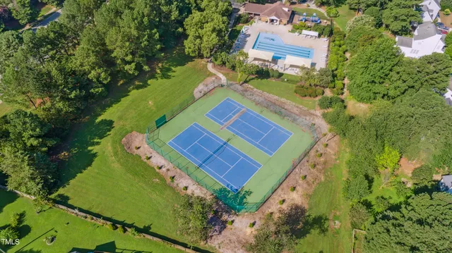 an aerial view of a house with swimming pool and garden