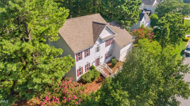 a view of a house with a small yard and potted plants