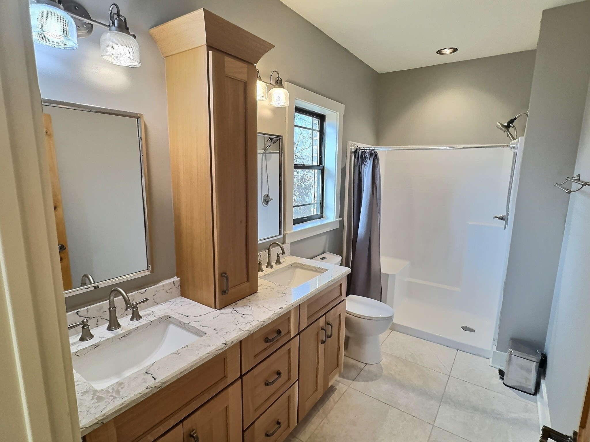 7307 Brush Creek Road Fairview, TN 37062 - Photo 14 of 41 a bathroom with a double vanity sink toilet mirror and shower