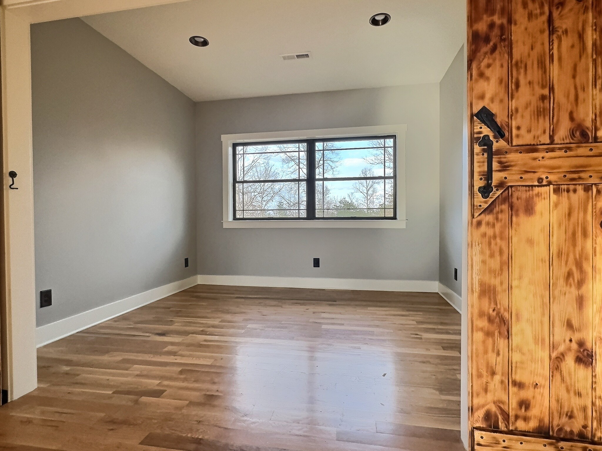 7307 Brush Creek Road Fairview, TN 37062 - Photo 19 of 41 a view of an empty room with wooden floor and a window