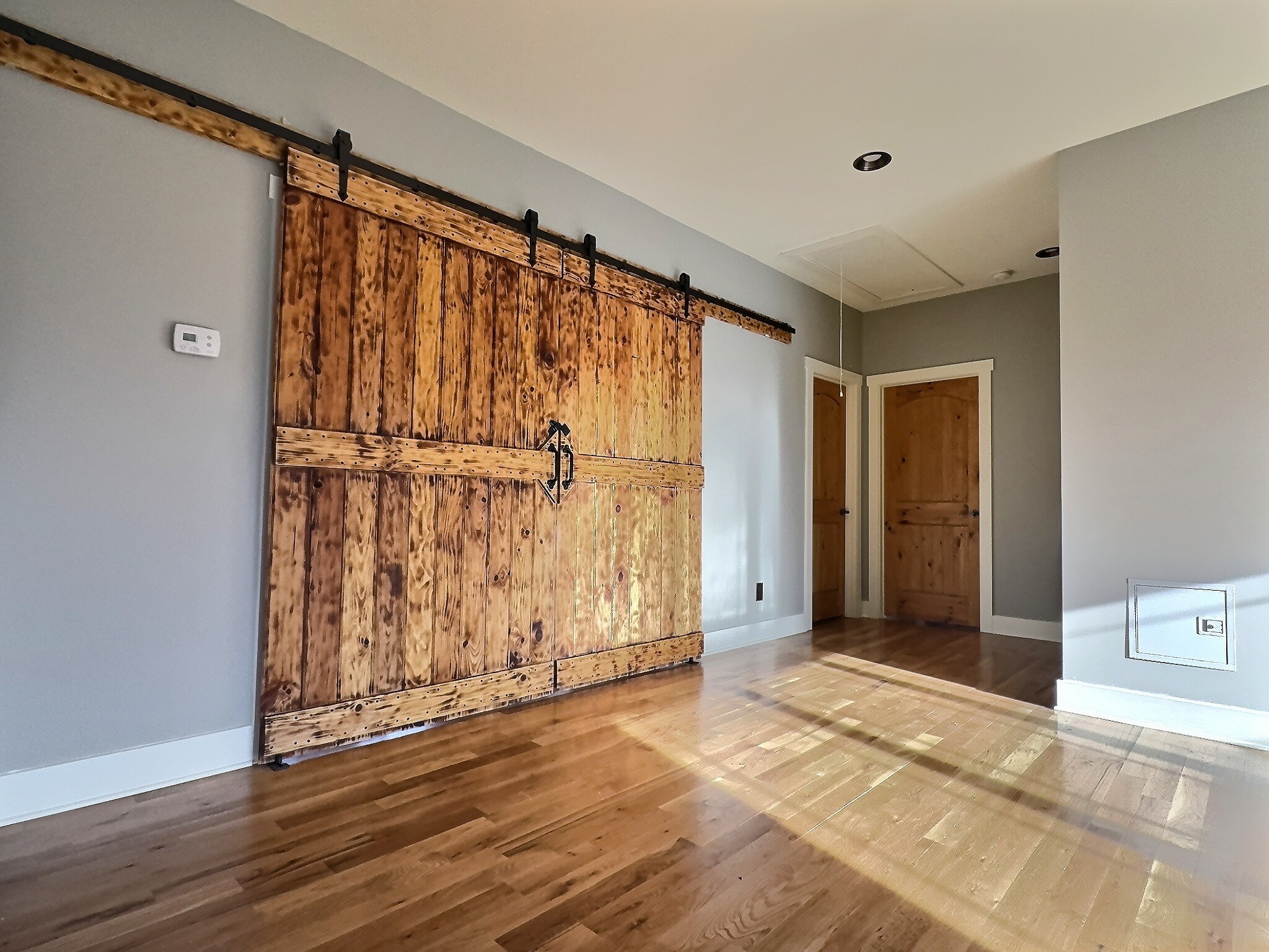 7307 Brush Creek Road Fairview, TN 37062 - Photo 20 of 41 an empty room with wooden floor and a cabinet door