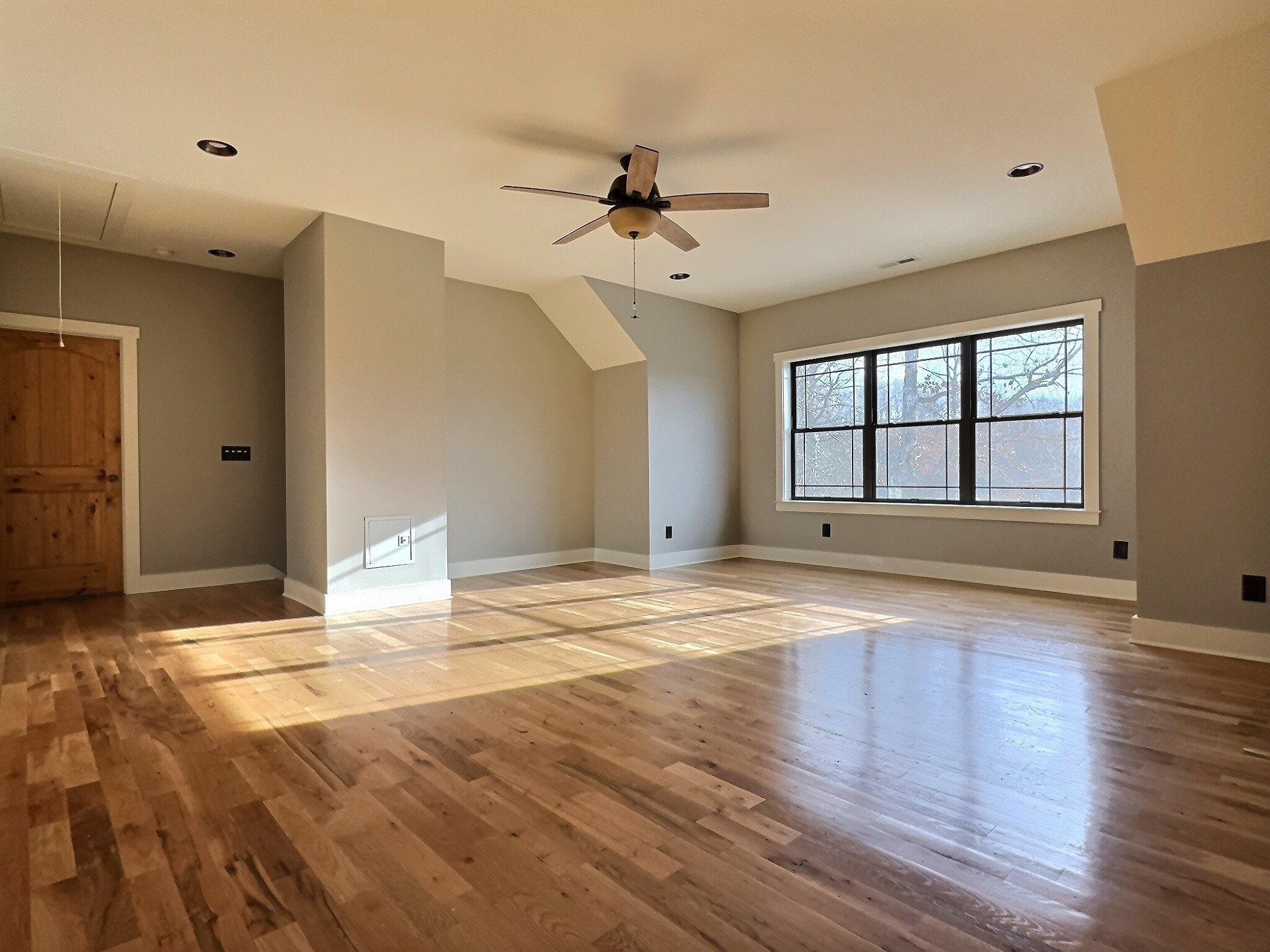 7307 Brush Creek Road Fairview, TN 37062 - Photo 8 of 41 a view of empty room with wooden floor and fan
