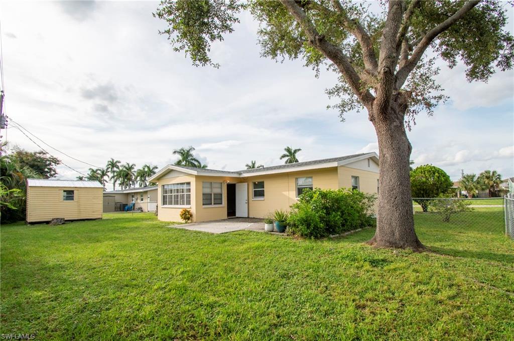 1442 Byron Road Fort Myers, FL 33919 - Photo 12 of 17 a view of a house with garden and a tree