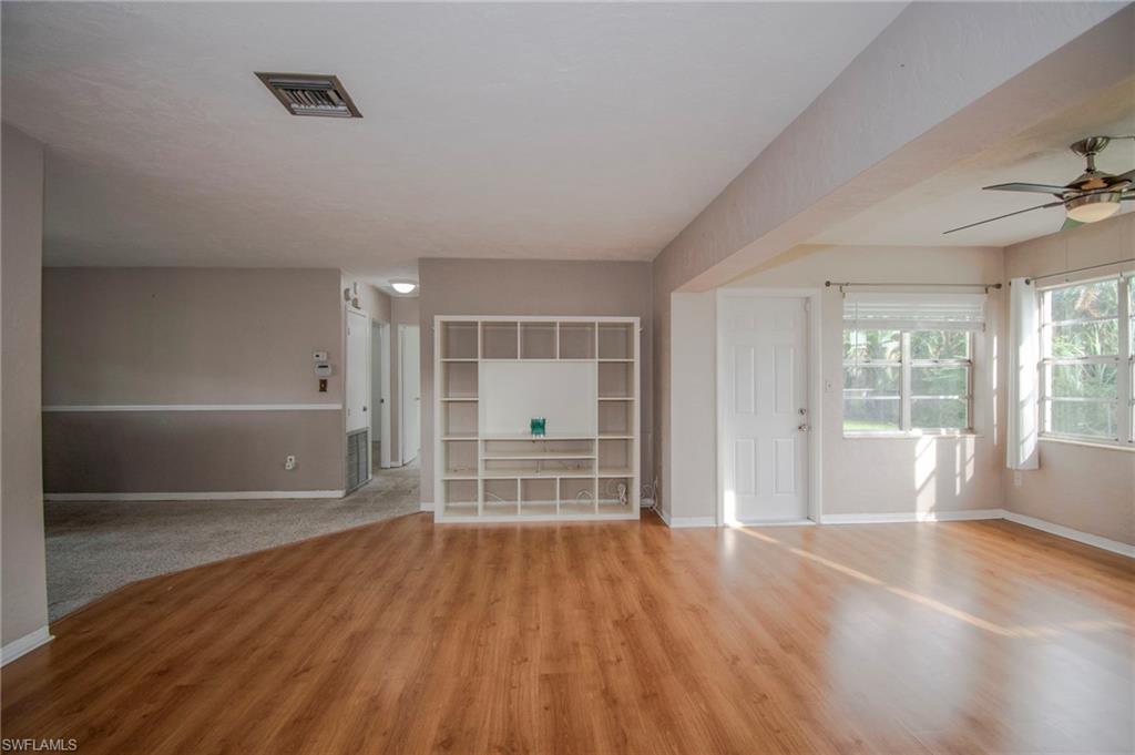 1442 Byron Road Fort Myers, FL 33919 - Photo 6 of 17 an empty room with wooden floor and windows