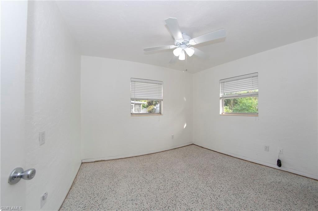 1442 Byron Road Fort Myers, FL 33919 - Photo 9 of 17 an empty room with a window and a fan