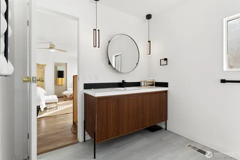 a bathroom with a sink a mirror and a shower