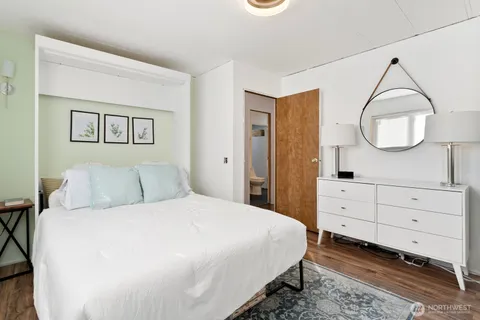 a bedroom with a bed and a mirror