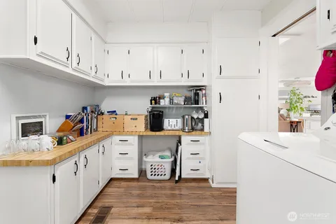 a kitchen with white cabinets sink and white appliances
