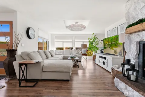 a living room with furniture fireplace and wooden floor