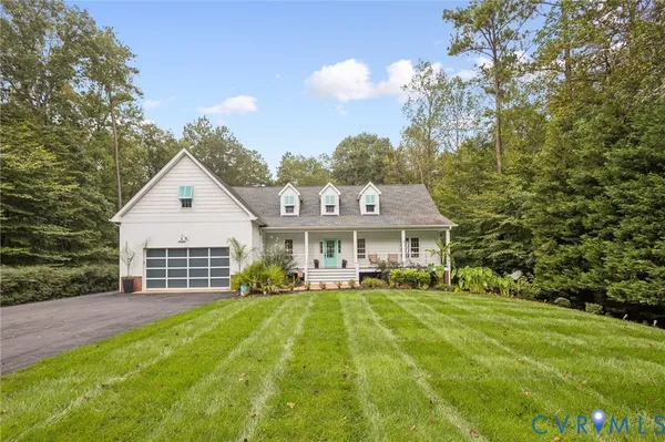 a view of house that has a yard