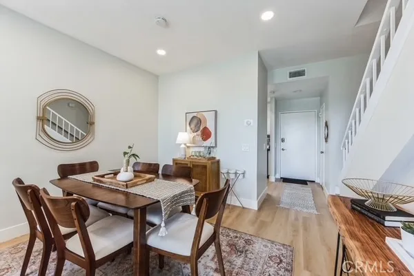 a view of a dining room with furniture and chandelier