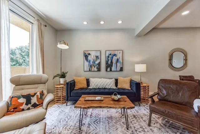 a living room with furniture and a large window