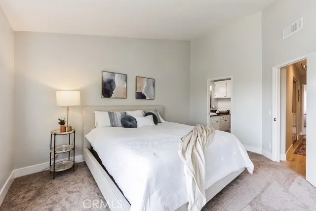 a bedroom with a bed and a night stand