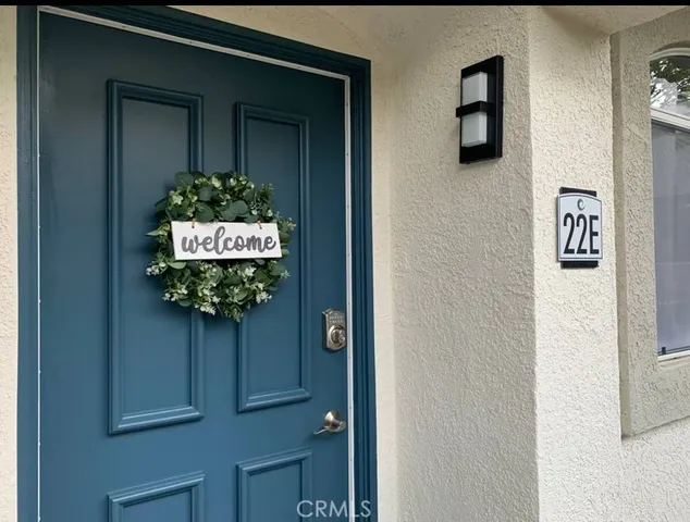 a vase of flowers sitting on a shelf in front of a door