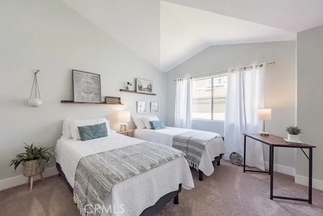 a bedroom with two beds and a window