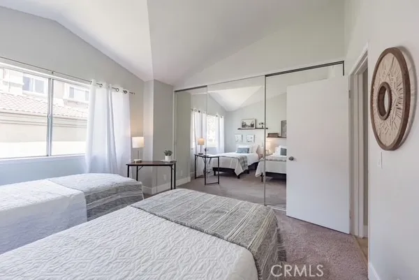 a bedroom with a bed couch and a window