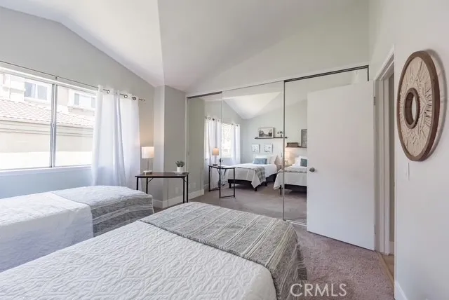 a bedroom with a bed couch and a window