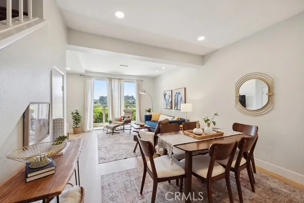 a dining room with furniture a rug and a chandelier