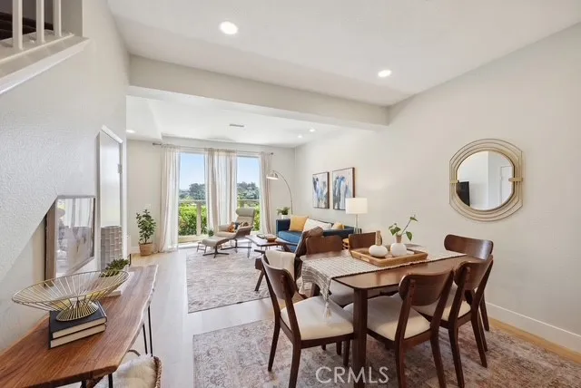 a dining room with furniture a rug and a chandelier