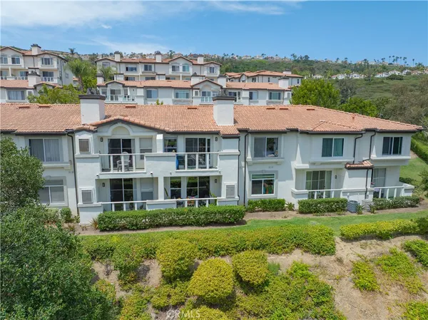 a front view of a residential apartment building with a yard