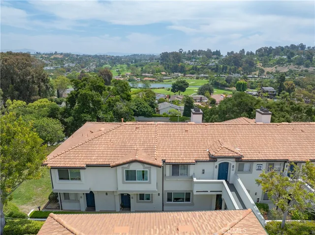 an aerial view of a house with a yard