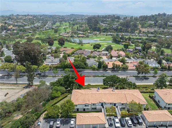 an aerial view of residential houses with outdoor space and river