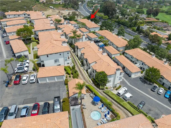 an aerial view of multiple houses with yard