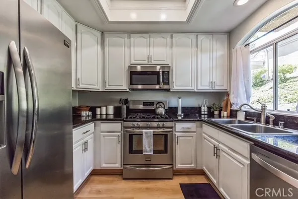 a kitchen with a stove a sink and a microwave