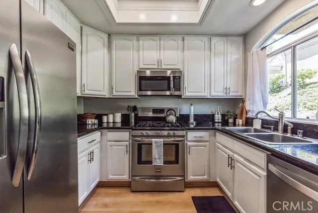 a kitchen with a stove a sink and a microwave