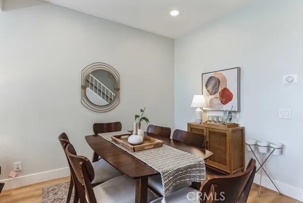 a dining room with furniture and a mirror