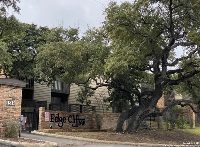 a front view of a building with tree s