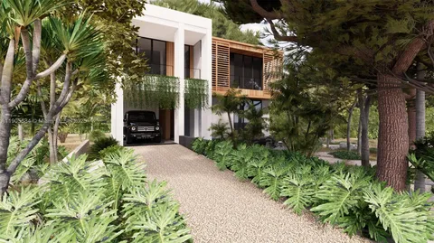 a front view of a house with a yard and potted plants