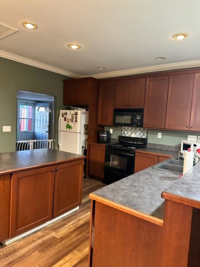 1338 Irene Road Cherry Valley, IL 61016 - Photo 6 of 15 a kitchen with stainless steel appliances granite countertop a stove a sink dishwasher and a refrigerator with wooden floor
