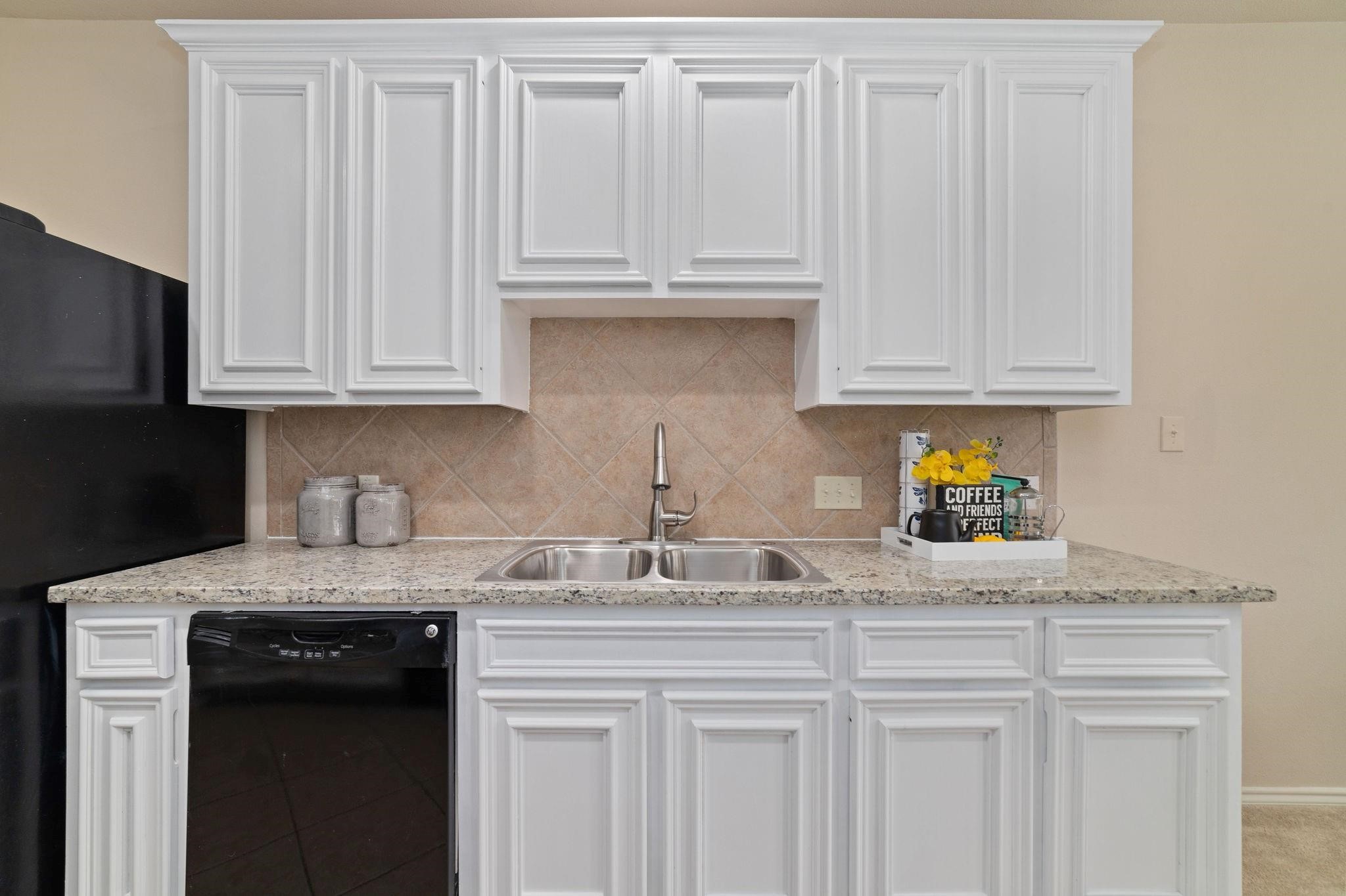 14923 Tuttle Point Drive Houston, TX 77082 - Photo 12 of 24 a kitchen with granite countertop white cabinets and a sink