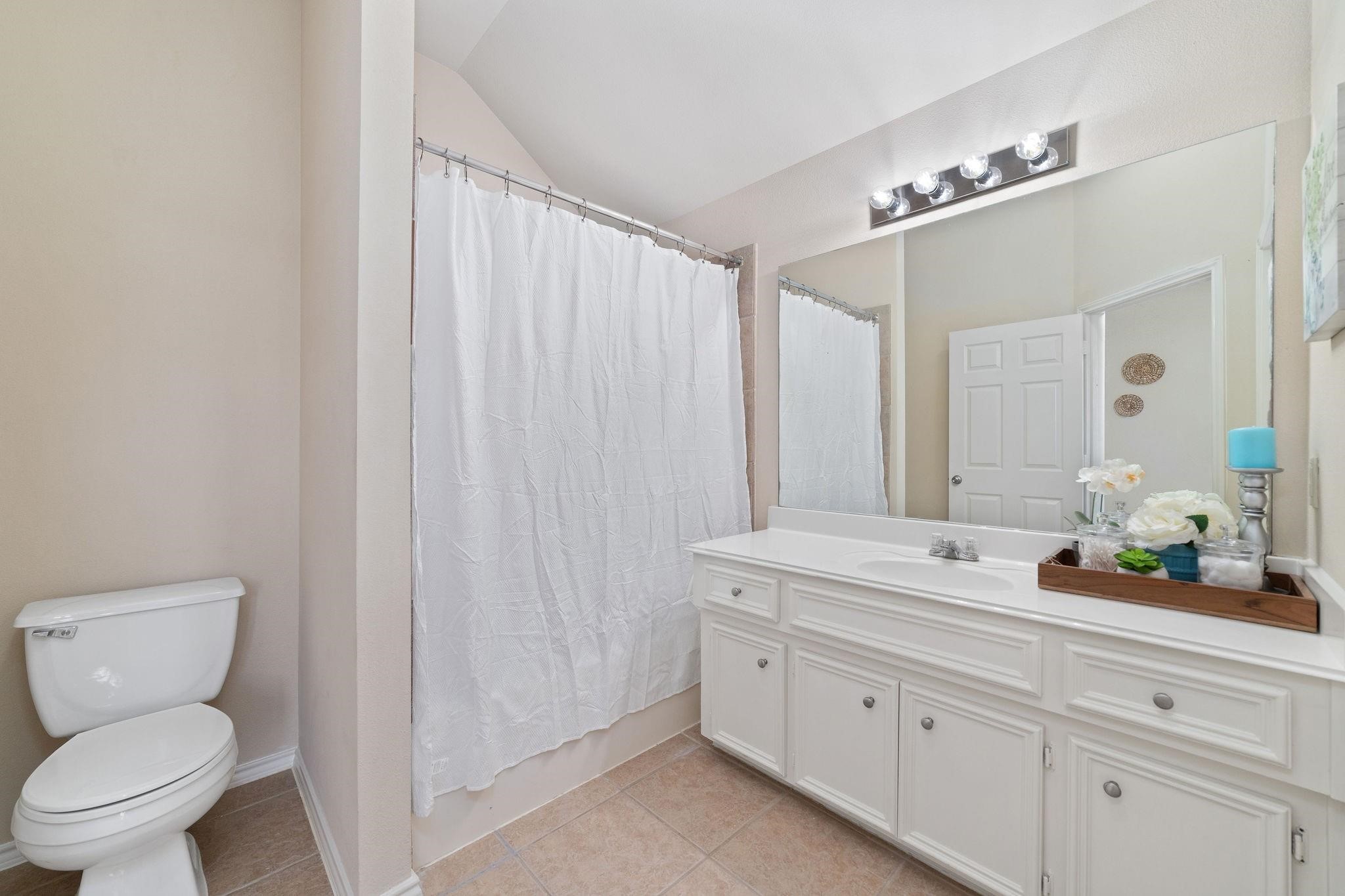 14923 Tuttle Point Drive Houston, TX 77082 - Photo 19 of 24 a bathroom with a toilet a sink and mirror