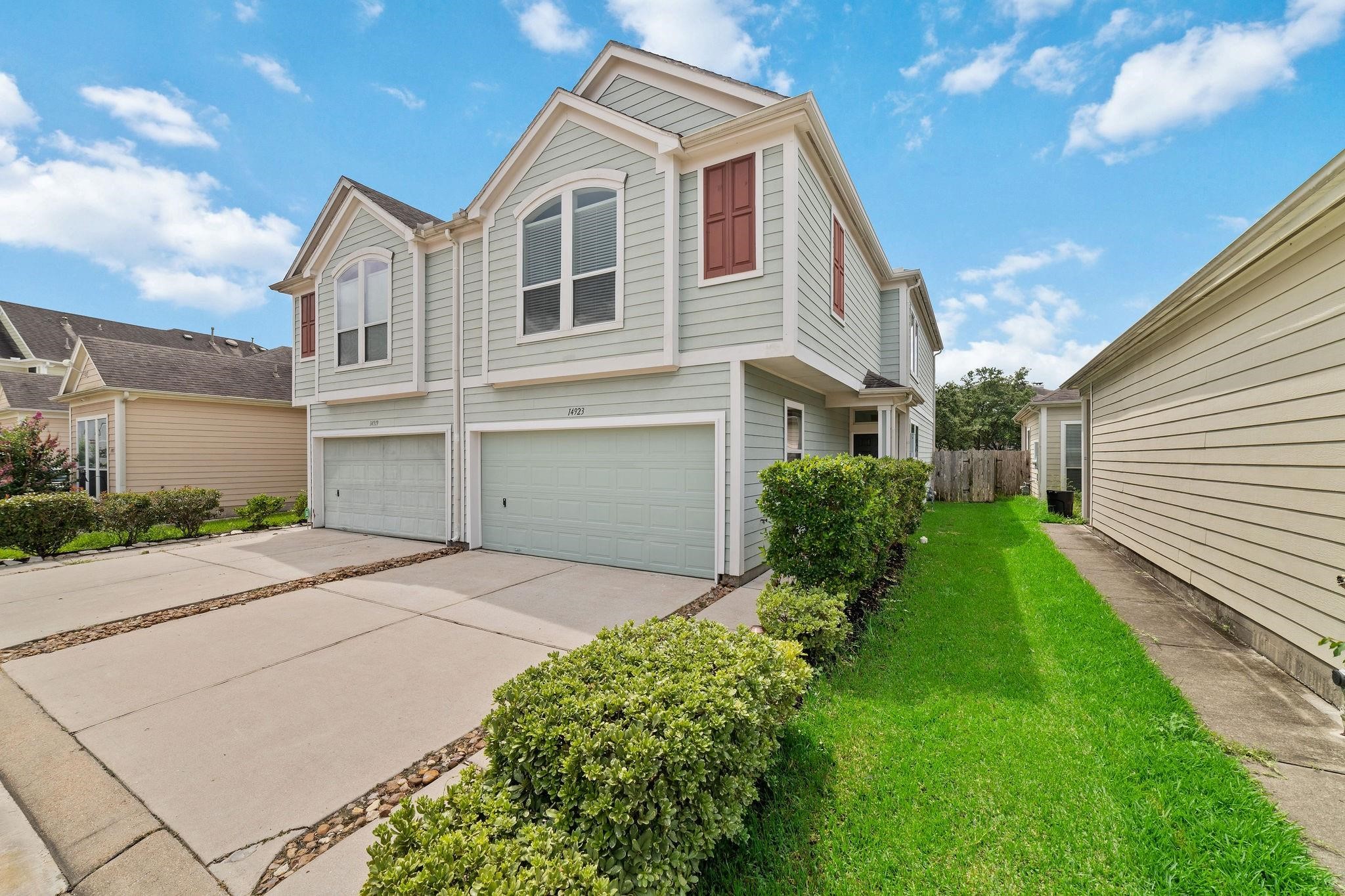 14923 Tuttle Point Drive Houston, TX 77082 - Photo 2 of 24 a front view of a house with a yard
