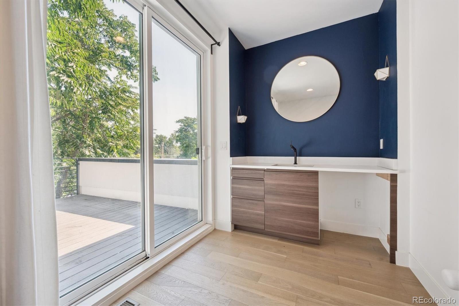 3124 Gilpin Street Denver, CO 80205 - Photo 16 of 46 a view of a room that has a bed and a mirror