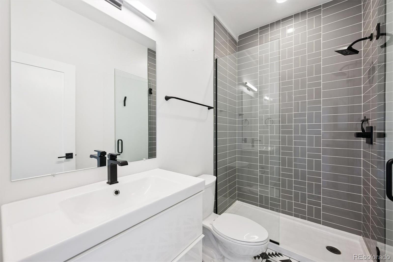 3124 Gilpin Street Denver, CO 80205 - Photo 18 of 46 a bathroom with a sink a toilet and shower