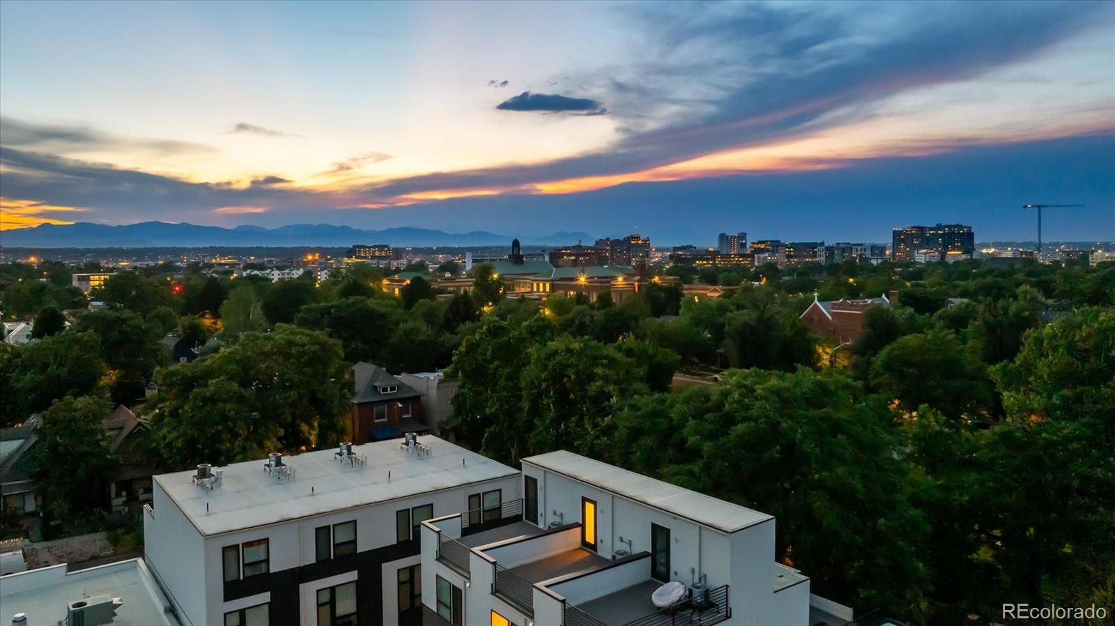3124 Gilpin Street Denver, CO 80205 - Photo 34 of 46 a view of a patio with a table and chairs under an umbrella