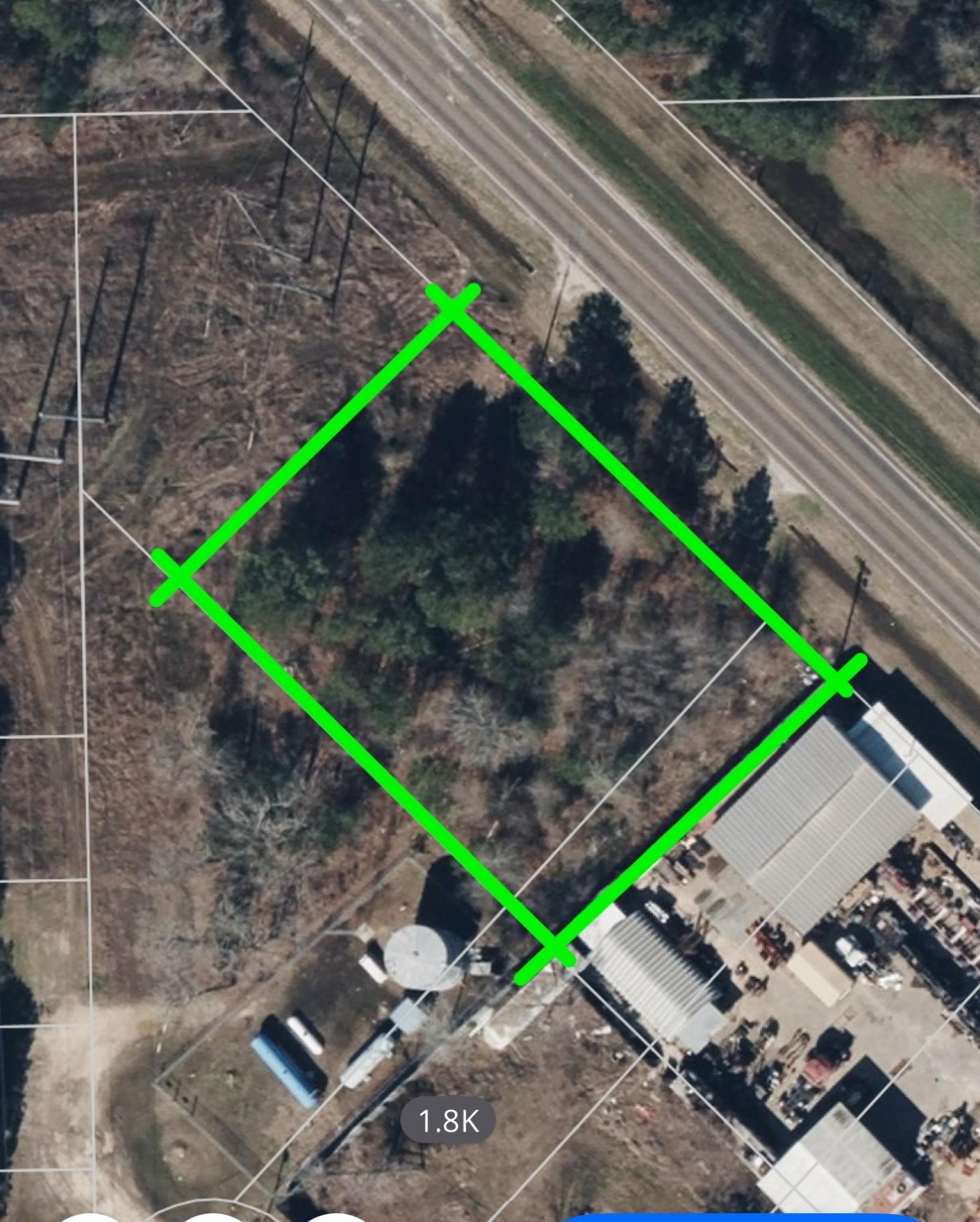 a green field with some trees in the background