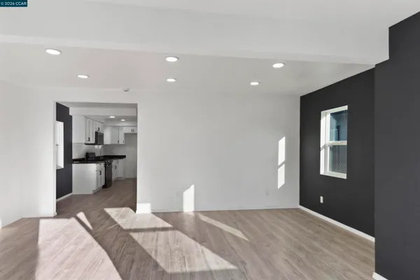 a bedroom with a bed and a view of kitchen