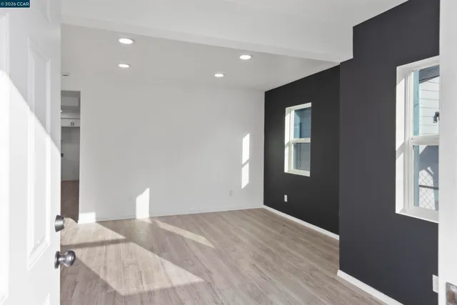 a view of a livingroom with wooden floor and staircase