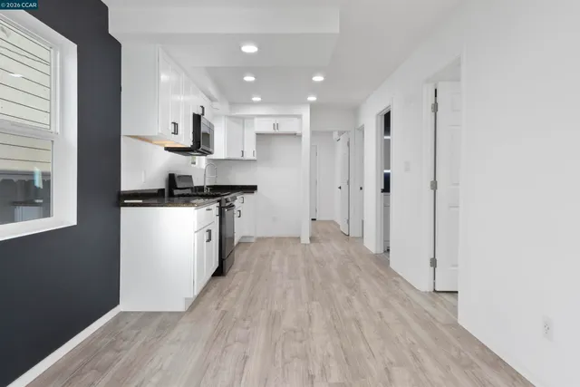a kitchen with a sink a refrigerator and window