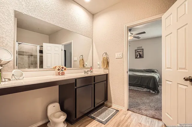 a en suite bathroom with a sink and a mirror