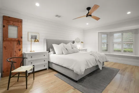 a bed room with a bed and a chair