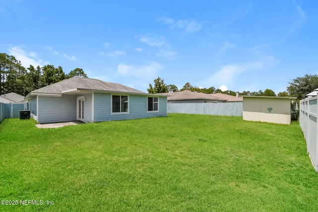 a front view of a house with a garden and yard