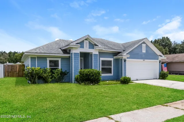 a front view of a house with a garden and plants