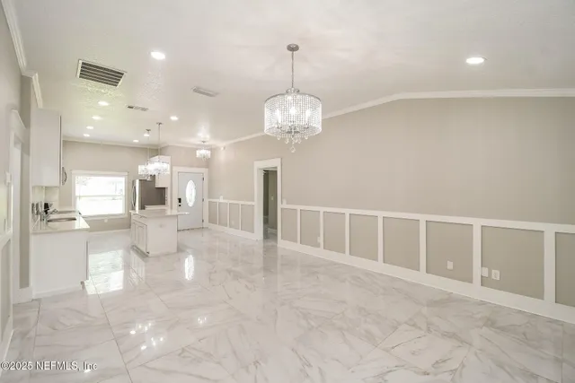 a view of a livingroom with a furniture wooden floor and a chandelier
