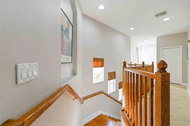 a living room with furniture a flat screen tv and a large window
